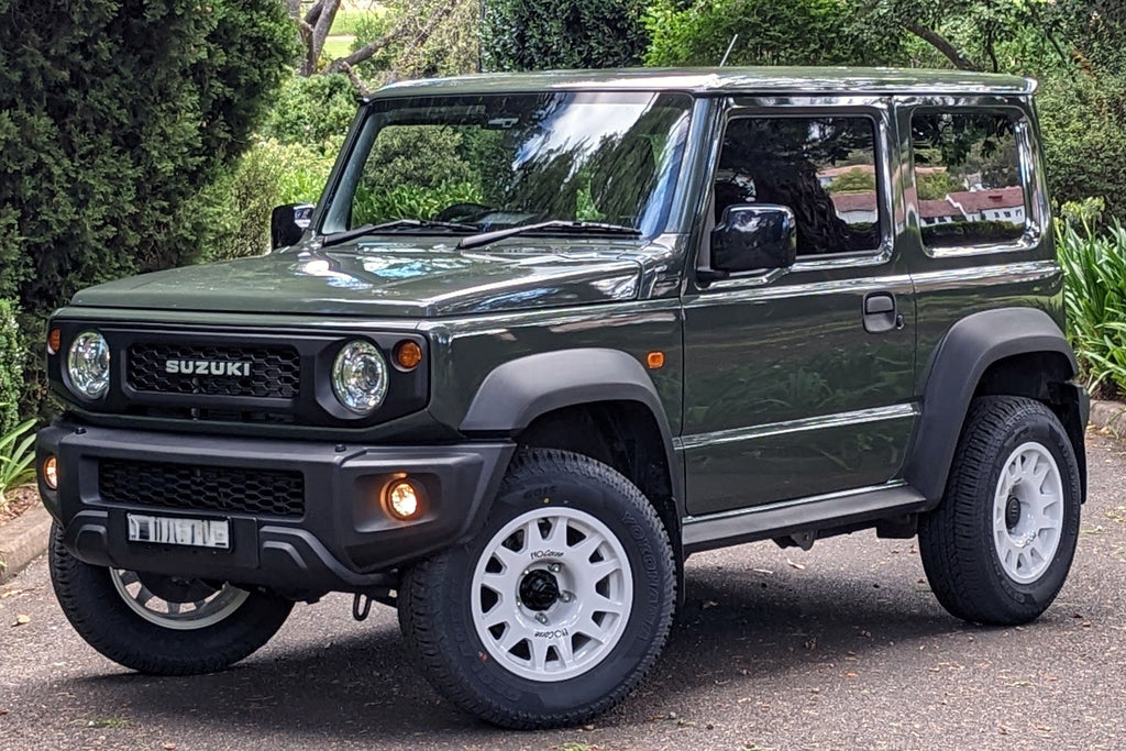 Jungle Green Suzuki Jimny (2018+) fitted with white EVO Corse DakarZero wheels