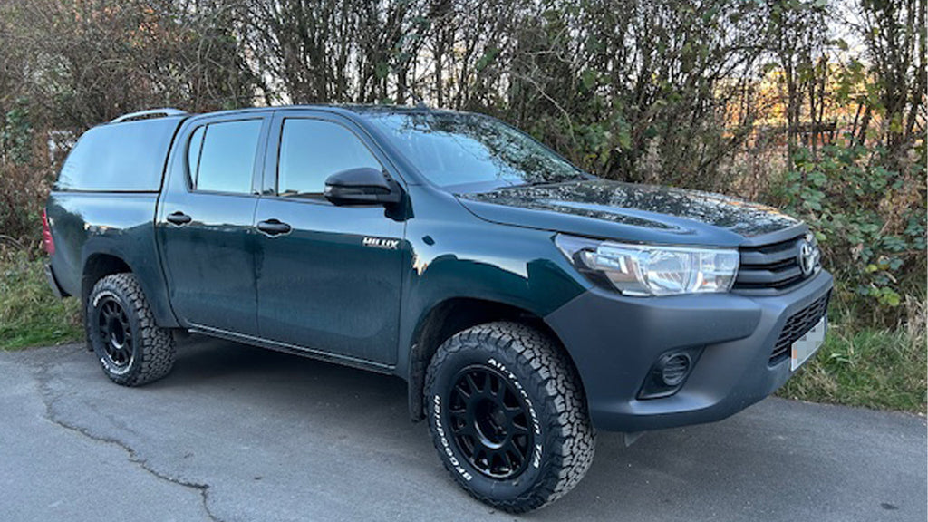 Green Toyota Hilux fitted with Matte Black EVO Corse DakarZero Wheels