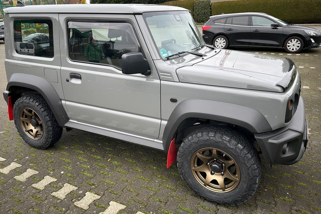 Grey Suzuki Jimny (2018+) fitted with Matte Bronze High Peak J-02 wheels